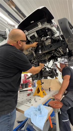 Now that the front axle has the ARTEC Industries truss and armour installed Dick Industries Inc and I can roll it back under the Gladiator and install it with the RockJock 4x4 by John Currie lift, geometry correction brackets, upper and lower control arms, bump stop, Currentlync high steer knuckles, tie rod, springs and track bar with Einhell and Milwaukee Tool tools. This RockJock stuff is way stronger and gets the steering components lifted higher and out of the way. Still more work to do but 