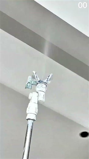long pole tool installs ceiling device as cables connect cleanly overhead #shorts