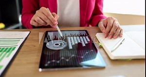Analyst woman watching financial statistical analytical charts for business on tablet. Applications for analyzing sales data