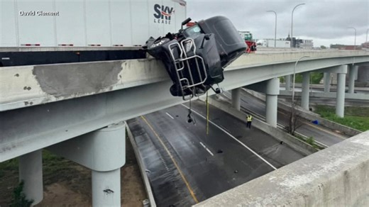 Crash leads to dramatic rescue of semi truck driver dangling off bridge