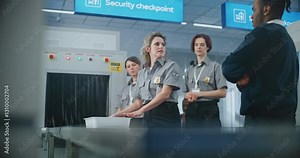 Airport Security Checkpoint: Female TSA Officer Provides Instruction to Airport Staff About X-ray Scanning Process on Metal Detector Conveyor Belt and TSA Screening Procedures before Boarding Flight.
