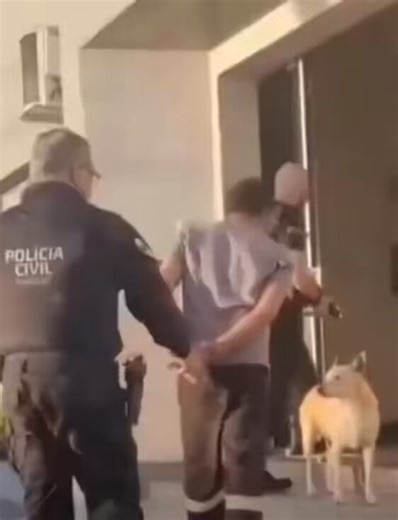 For a moment, the officer forgot he was arresting someone to pet a dog. I would do the same