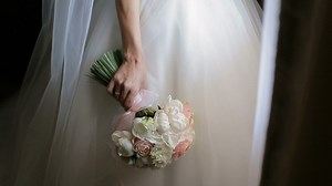 Bride in wedding dress smells bouquet of roses - Free Stock Video