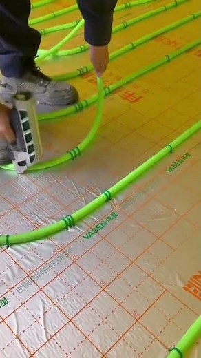 the process of arranging the green electrical cable protector or PVC pipe on the floor.