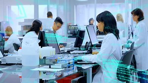 Premium stock video - Animation of chemical formulas and data processing over diverse lab workers using computers