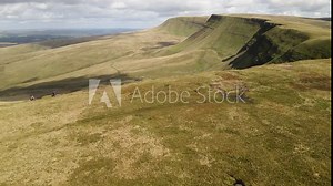 Vast trekking Llyn y fan Fach mountain range Brecon beacons aerial view reveal idyllic blue lake