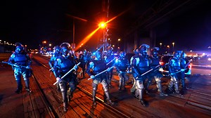 Policing experts say outfitting cops in military-style gear turns up the heat at protests