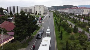 SOCHI, RUSSIA - October 1, 2021: Autumn in the resort city of Sochi, a street taken from a drone. Public transport and city life.