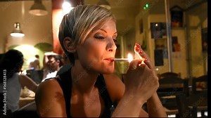woman is smoking a cigarette after dinner