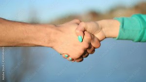 Man and woman shaking hands outdoor. Handshake