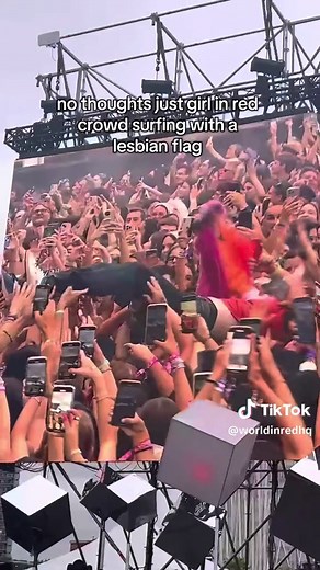 Girl in Red Crowd Surfing with Lesbian Flag