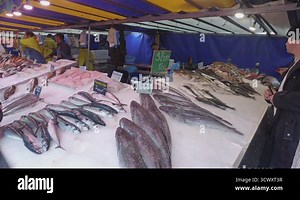 PARIS, FRANCE - circa MAY, 2017: People buy seafood at Marche des Enfants Rouges ("Red Children Market "). This oldest covered market in Paris known for its fresh produce and variety of food stalls Stock Video Footage - Alamy