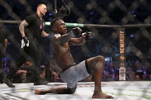 Israel Adesanya reacts to Jared Cannonier’s loss to Robert Whittaker at UFC 254