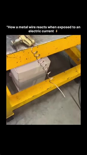 𝙒𝙊𝙍𝙇𝘿 𝙒𝙄𝘿𝙀 on Instagram: "The video depicts a setup demonstrating the Joule heating effect in a thin metal wire. A coiled wire is connected via an alligator clip to an electrical power source on a metal surface beneath a yellow metal frame, likely a workbench. When current is applied, the wire rapidly heats due to its high resistance, glowing red-hot and potentially melting or deforming, illustrating resistive heating in conductors. Specific upload date is not identifiable from availabl