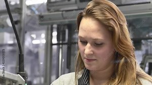 Product Assembly / Montage - Professional Production Female Operator is Screwing the Component in the Assembly Line by Industrial Automatic Electric Screwdriver in Automotive Industrial Factory