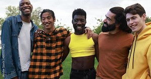 Young diverse men having fun laughing together at city park