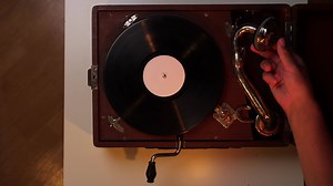 pov top view turning on music playback on an old vintage turntable gramophone