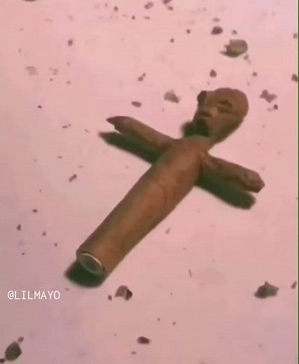 Alien rolling and smoking weed blunt