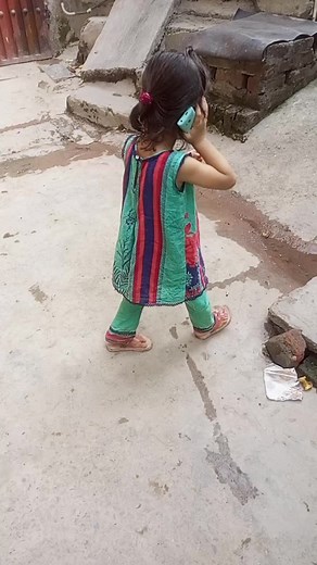 Young Girl Playfully Talking on Her Mobile Phone