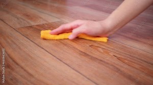 A housewife washes and disinfects the floor in the house. Close-up of a woman's hands wiping the floor with a rag.