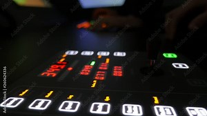 Navy officer looking at a dashboard with red digits, blue and white icons in cabin