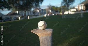 Hurling Ireland sport action player lifts balances and bounces sliotar ball on hurley stick