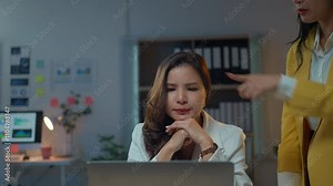 Manager reprimanding an employee working late in the office, highlighting tension and stress during a challenging work situation