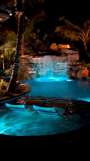 This South Florida Insane Pool shines bright at night. We create a jaw-dropping environment of recreation and relaxation that is 100% customized and unique to every client! #insanepools #lucaslagoons #poolbuilder #pool #backyard | Lucas Lagoons