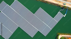 Floating solar panels and cell platform on the pond. Innovation of renewable clean energy for the environment. Renewable electric energy industry. aerial view from drone. 4k