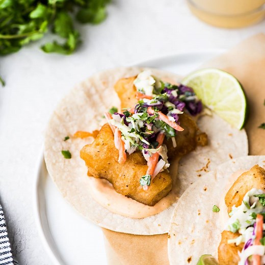 The best Baja Fish Tacos you’ll ever eat! 🙌 They’re filled with crispy beer-battered fish, smoky chipotle mayo and a creamy cabbage slaw! Full printable recipe: https://www.isabeleats.com/baja-fish-tacos/ | Isabel Eats - Easy Mexican Inspired Recipes