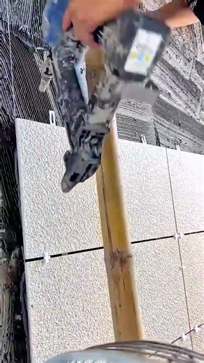 installing textured ceramic wall decorations using special glue and an electric nail gun tool