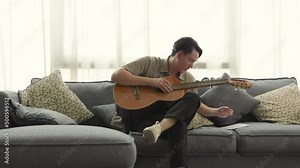 musician playing the guitar and writing lyrics in notepad while creating new song