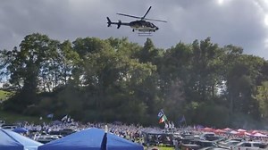 Crowd scrambles as police helicopter flies low