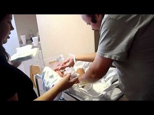 Dad changes baby diaper