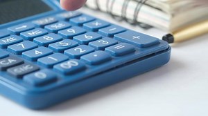 Blue calculator with a planner in the background