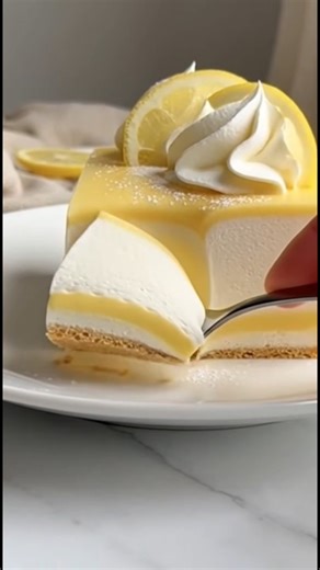 No-Bake Lemon Mousse Layer Cake Every Sunday, this lemon cheesecake brought our family back to the table bright, creamy, and full of sunshine. One slice, and suddenly the kitchen is filled with laughter, stories, and sweet memories. Ingredients: For the Crust: - 1 1/2 cups digestive biscuit or graham cracker crumbs - 1/3 cup unsalted butter, melted - 2 tablespoons sugar For the Lemon Gel Layer: - 1 cup fresh lemon juice - 1 tablespoon lemon zest - 1/2 cup granulated sugar - 1 tablespoon cornstar