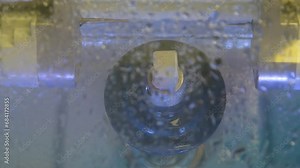 Fabrication of dental crowns and dentures made of ceramic. The milling machine cuts the ceramic dental crown from the workpiece.