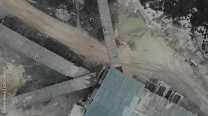 Stone crusher (rock stone crushing machine) at open pit mining and processing plant for crushed stone,limestone and gravel. The camera lands above the stone crusher. Aerial view 4K Stock Video