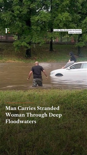 Man Carries Stranded Woman Through Deep Floodwaters | N18G