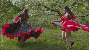 two women in gypsy clothes dancing in slow motion