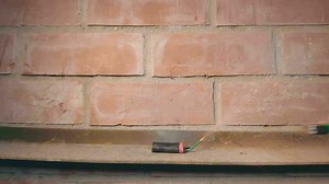 Download Firecracker Was Lighted Up With a Gas Lighter then Explode Against a Brick Wall Super Slow Motion. Many Small Particles Flew in a Different Directions Static Shot for free