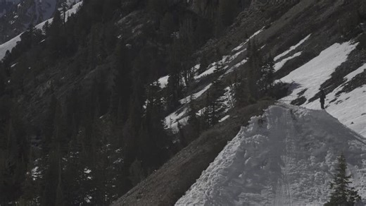 Skier does rodeo flip off of snow slope