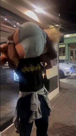 Black Guy lifts up White Girl in arms