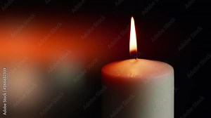The showcases of colorful single candlelight on black background with the effect of light and slow motion.