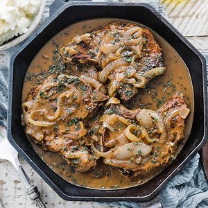 These Smothered Pork Chops in a Caramelized Onions Gravy are INCREDIBLE! Recipe at https://bit.ly/2SaLw20 | Chef Billy Parisi