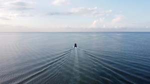 Aerial view follow the back of fishing boat