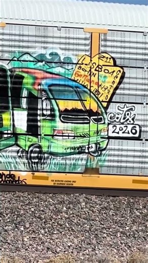 Stopped railroad train with graffiti spray painting the autorack rail cars