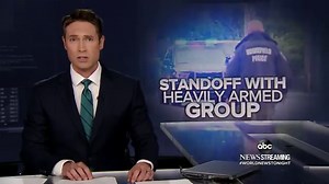 Nearly a dozen armed men arrested in police standoff