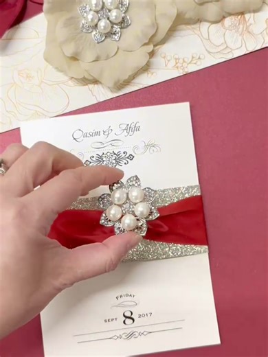 Stephita Wedding Invitations. Creating a custom pocket fold wedding invitation with glitter band, red ribbon and a vintage style sparkling pearl and rhinestone brooch. . . . #wedding #weddingtiktok #weddingdress #weddingday #weddingvibes