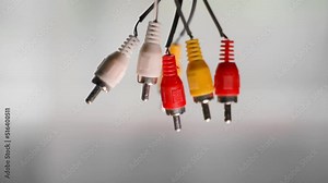 Old rca connectors for audio and video signal transmission close-up on a blurred background. Tulip plug with bad quality bare wires
